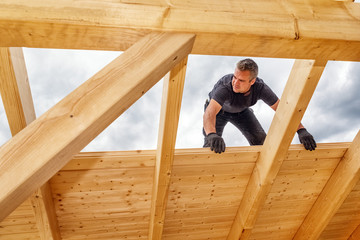 Carpenters Setting up a Timber Roof Truss