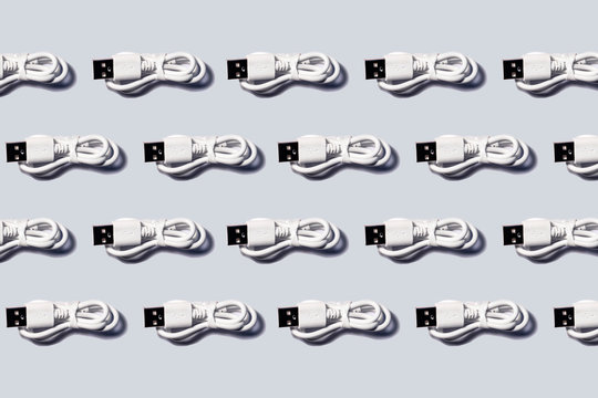 3D Illustration, white USB cables in a row on gray background