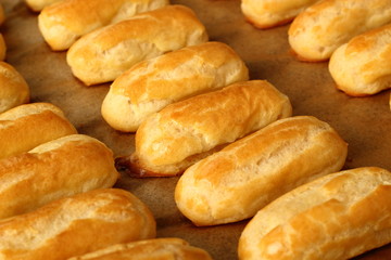 Freshly baked choux pastry. Making Eclair.