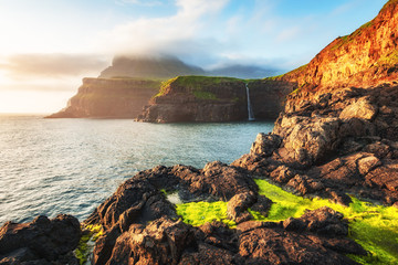 Incredible view of Mulafossur waterfall in Gasadalur village, Vagar Island of the Faroe Islands, Denmark. Landscape photography