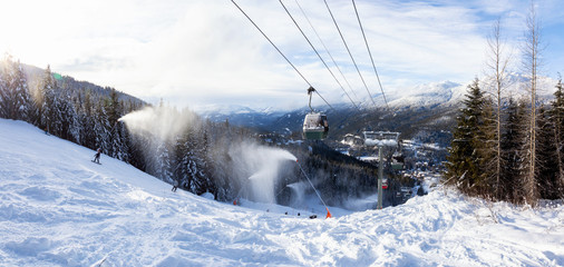 Whistler, British Columbia, Canada. Gondola going up the mountain during a vibrant and sunny winter...