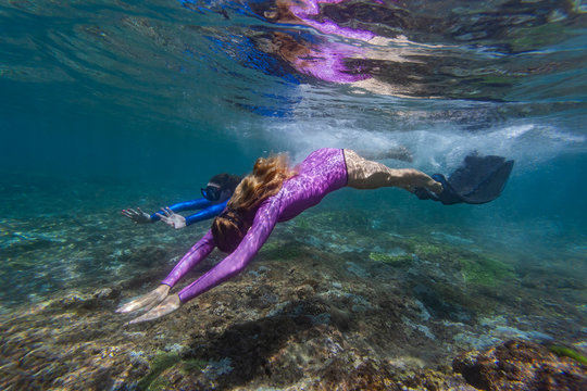 Two young women snorkeling in Nusa Penida island, Bali, Indonesia