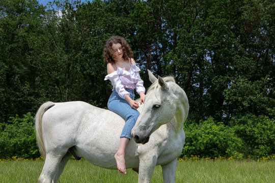Young woman riding bareback on a horse