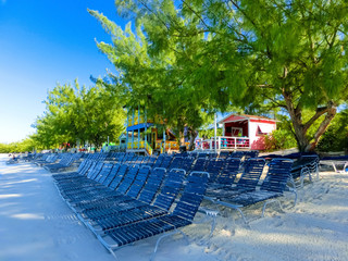 Colorful tropical cabanas or shelters on the beach of Half Moon Cay