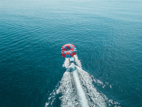 Indonesia, Bali, Nusa Dua, Aerial view of person parasailing and motorboat