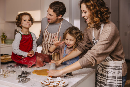 Family preparing Christmas cookies in kitchen