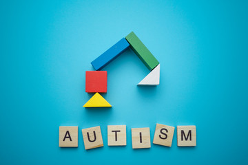 autism lettering made of wooden cubes with building colourful wooden blocks. autistic conceptual