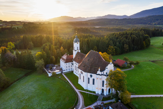Germany, Bavaria, Upper Bavaria, Pfaffenwinkel, Wies, Aerial view of Pilgrimage Church of Wies to the Scourged Savior at sunrise