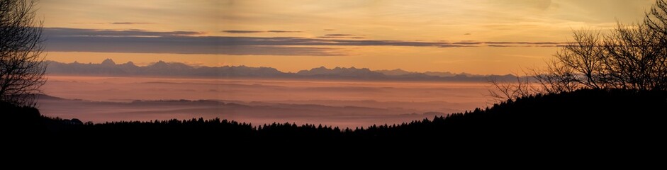 High resolution stitched panorama of a beautiful sunset with the distant alps in the background near Daxstein, Bavarian forest, Bavaria, Germany