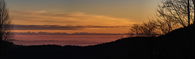 High resolution stitched panorama of a beautiful sunset with the distant alps in the background near Daxstein, Bavarian forest, Bavaria, Germany