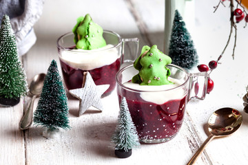 Cups of red porridge with green macaroon Christmas trees