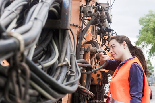Female technician examining truck