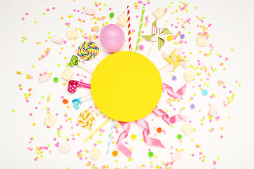 Obraz premium Colorful flat lay composition with various party items and candies on white background