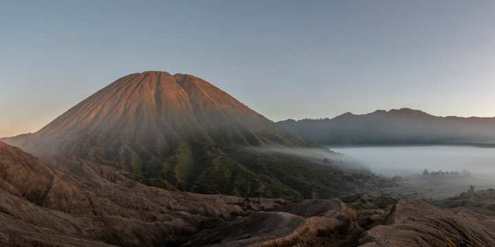 Indonesia, East Java, Aerial panorama of Mount Bromo shrouded in morning fog