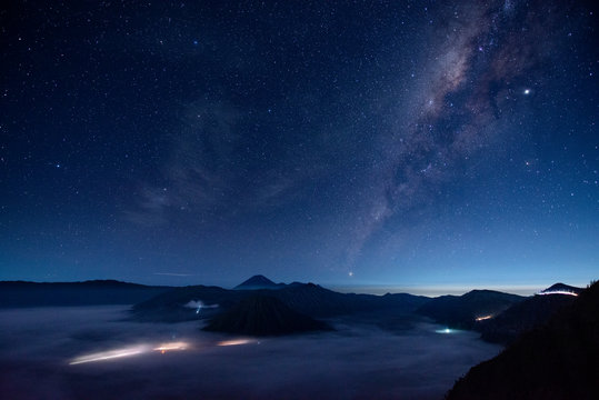 Indonesia, East Java, Scenic view of Milky Way galaxy on starry night sky over Mount Bromo shrouded in fog