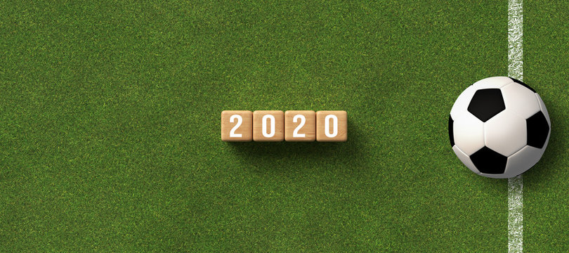 number 2020 on cubes lying on green grass background with a soccer ball - 3D rendered illustration