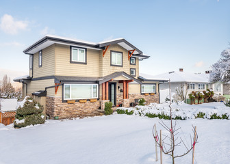 A perfect neighbourhood. Houses in suburb at Winter in the north America. Luxury houses covered nice snow.