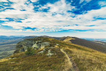 spring time highland rocky mountain landscape scenic view windy plateau top wilderness environment cloudy blue sky background, copy space