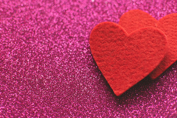 Fototapeta premium Red felt hearts on a pink shiny background. Valentine's Day