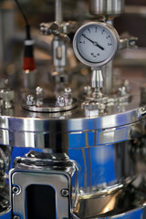 Fototapeta na wymiar pharmaceutical reactor with analog pressure gauge