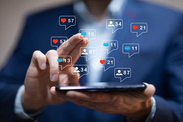 man hand using smartphone with colorful application icons around