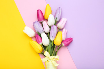 Bouquet of tulip flowers on colorful background