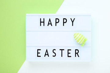Lightbox with words Happy Easter and egg on colorful background