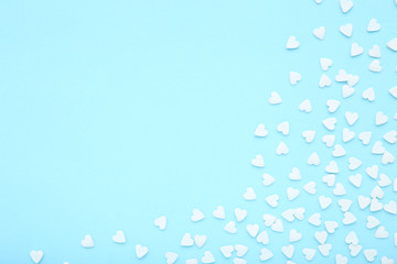 Heart shaped sprinkles on blue background