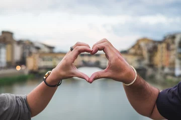 Foto op Canvas Young couple hands united in a heart shape. Florence Italy © ballero
