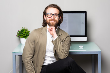 Portrait of smiling young businessman looking at camera in office