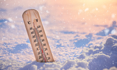 Wooden thermometer in the winter. 