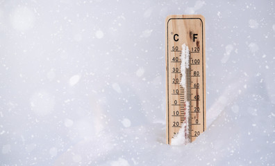 Wooden thermometer in the winter. 