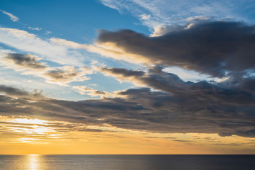 Early sunrise and epic cloudy sky at rocky seashore coast of Torrevieja, Alicante, Spain. Mediterranean sea 2019