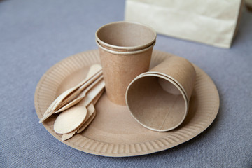 eco paper plate dish fork on old wooden table