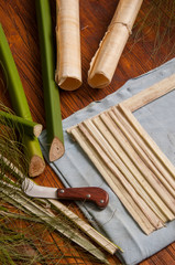 The making of papyrus paper: Strips obtained from the stem of the plant with a typical knife and finished rolled up sheets