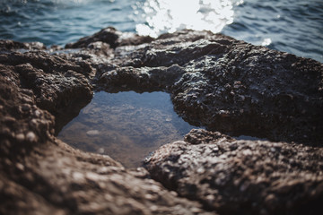 A puddle in the stone after the surf. Croatia