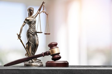 Statue of the lady of justice with scales on the background