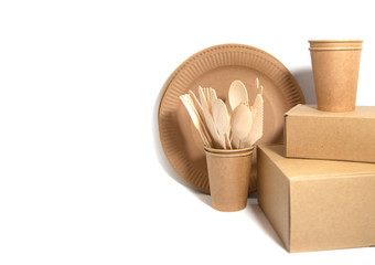 Crockery made from eco kraft paper, paper cups, dishes, bag, fast food containers isolated on white background. Recycling concept. Zero waste. Close-up..