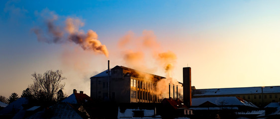 Industrial factory smoke over the sunrise city