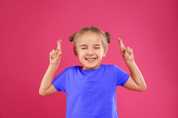 Cute little girl posing on pink background