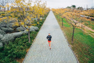 Senior retired man runs and performs exercise