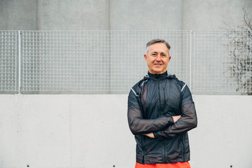 Portrait of retired senior man runs and performs exercise