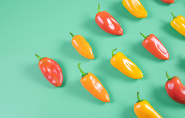 red and yellow mini bell pepper in mint background