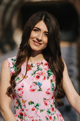 Portrait of beautiful young girl in flower dress with fashion makeup