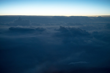 Obraz premium blue sky background with white clouds. Puffy clouds horizon. View from the airplane window. DARK BLUE CLOUDS BACKGROUND, NATURE BLUE SKIES