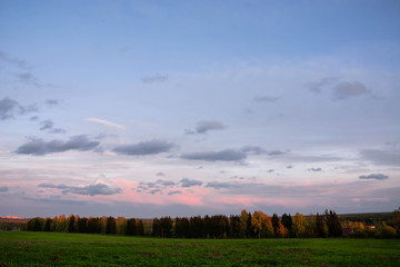 Autumn landscape. Russian nature.Cloudy weather. Meadow and trees. Horizon line.