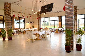 Restaurant hall with indoor plants on the floor