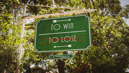 Obraz premium Street Sign TO WIN versus TO LOSE
