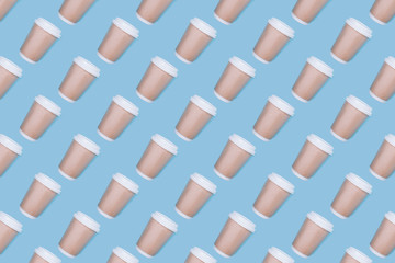 Pattern of coffee cups on a blue background. Flat lay.