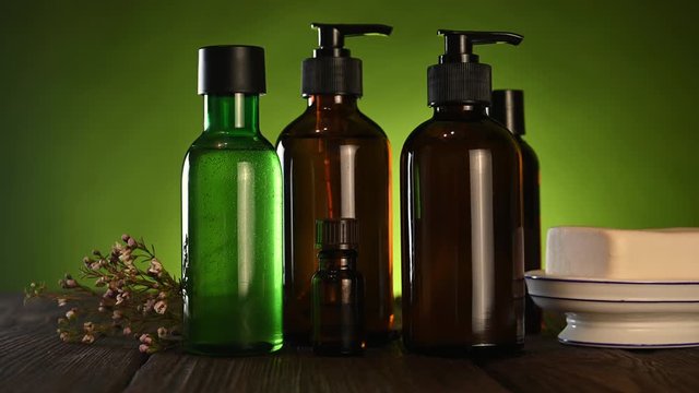 shower gel, soap, shampoo stand on a wooden table